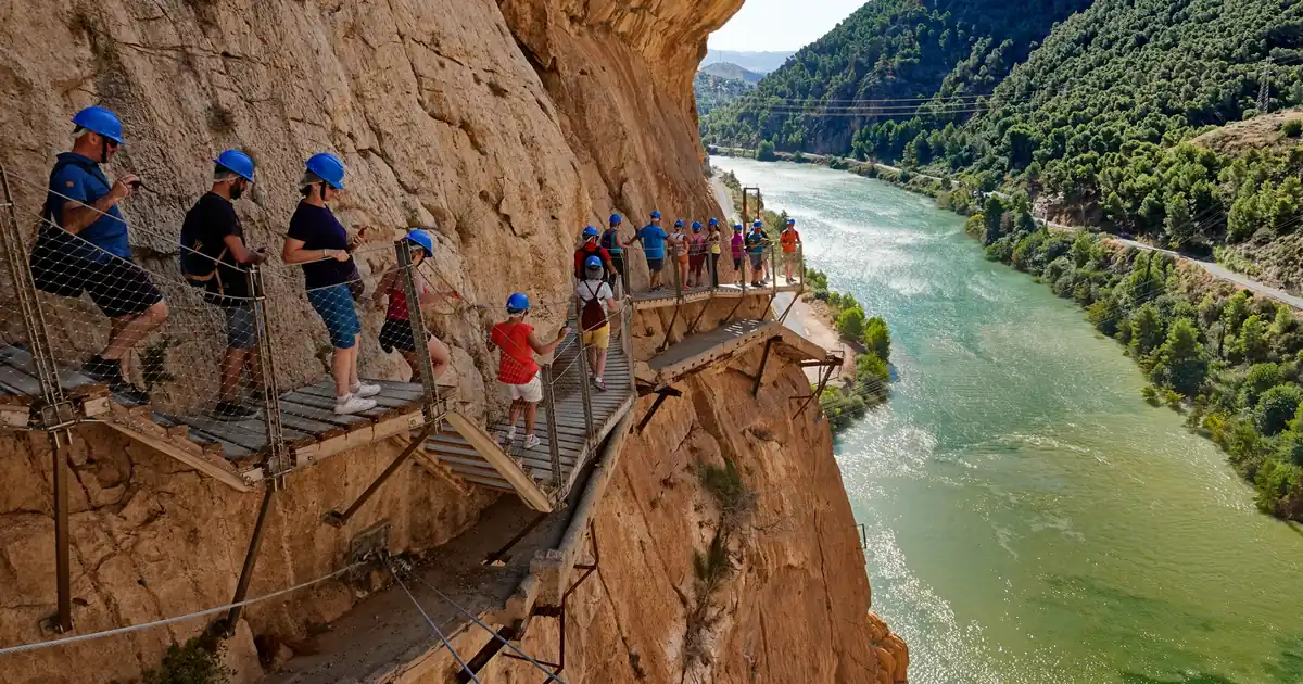 The narrow wooden boardwalk of Caminito del Rey suspended 100 metres above the Gaitanes Gorge in Malaga.