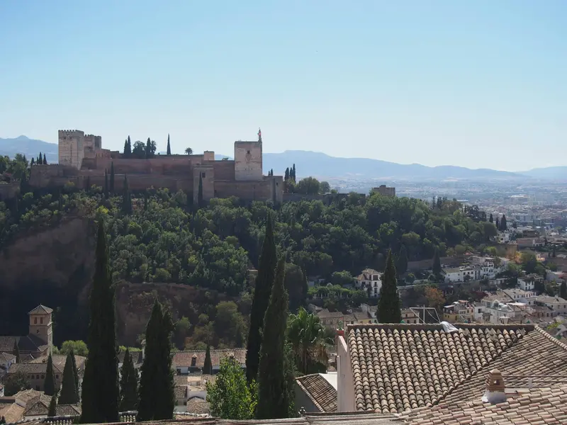 View of Alhambra Palace and grey rooftops of Granada, Spain, from above